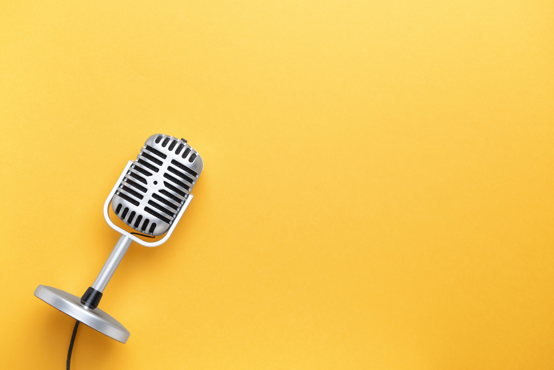 Retro microphone on color background